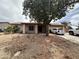 Modest single-story home with a low-pitched roof and desert landscaping at 2209 W Los Arboles Pl, Chandler, AZ 85224