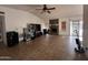 Open living room featuring tile floors, a vaulted ceiling and a stone fireplace at 2209 W Los Arboles Pl, Chandler, AZ 85224