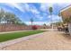 Backyard with an artificial lawn, gravel landscaping, and a covered patio with outdoor seating at 2821 E Larkspur Dr, Phoenix, AZ 85032