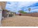 Spacious backyard with gravel landscaping, a small patio, and a brick perimeter wall at 2821 E Larkspur Dr, Phoenix, AZ 85032