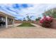 Backyard with an artificial lawn area, a patio, gravel landscaping, and a perimeter wall at 2821 E Larkspur Dr, Phoenix, AZ 85032