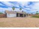 Backyard view featuring a patio with outdoor furniture, gravel landscaping, and a grassy area at 2821 E Larkspur Dr, Phoenix, AZ 85032