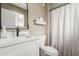 Bathroom features a white vanity with a black faucet and a shower with a white curtain at 2821 E Larkspur Dr, Phoenix, AZ 85032