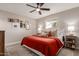 Cozy bedroom with ceiling fan, neutral walls, and multiple framed photos at 2821 E Larkspur Dr, Phoenix, AZ 85032