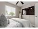 Bright bedroom with large TV, ceiling fan, and a view to the outside at 2821 E Larkspur Dr, Phoenix, AZ 85032