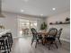 Open-concept dining area featuring modern table and chairs, barstool seating, and access to the backyard at 2821 E Larkspur Dr, Phoenix, AZ 85032
