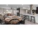Open-concept dining area with a view of the living room and kitchen, seamlessly connected for modern living at 2821 E Larkspur Dr, Phoenix, AZ 85032