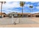 Charming home with desert landscaping, sidewalk, and a yellow front door provides excellent curb appeal at 2821 E Larkspur Dr, Phoenix, AZ 85032