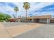 Charming home with desert landscaping, driveway, and a yellow front door provides excellent curb appeal at 2821 E Larkspur Dr, Phoenix, AZ 85032