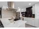 Modern kitchen with stainless steel appliances, black backsplash, and large island with seating at 2821 E Larkspur Dr, Phoenix, AZ 85032
