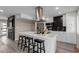 Modern kitchen features a large island, stainless steel appliances, and sleek black backsplash at 2821 E Larkspur Dr, Phoenix, AZ 85032