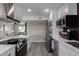 Open concept kitchen with stainless steel appliances and view into living area at 2821 E Larkspur Dr, Phoenix, AZ 85032