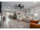 Open-concept living room featuring modern decor, a sectional sofa, and a dining table at 2821 E Larkspur Dr, Phoenix, AZ 85032