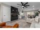 Open-concept living room featuring a modern fireplace, kitchen, dining area, and barstool seating at 2821 E Larkspur Dr, Phoenix, AZ 85032