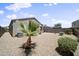 Low-maintenance backyard with gravel landscaping, desert plants, and block wall at 31051 W Amelia Ave, Buckeye, AZ 85396