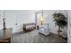 Bedroom with a crib, gray chair, natural light, and elephant sculpture at 31051 W Amelia Ave, Buckeye, AZ 85396