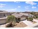 Well-maintained home with mature landscaping, a covered porch, and a two-car garage at 31051 W Amelia Ave, Buckeye, AZ 85396