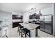 Spacious kitchen featuring granite countertops, stainless steel appliances, and a breakfast bar with seating at 31051 W Amelia Ave, Buckeye, AZ 85396