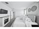 Main bedroom featuring an electric fireplace and a luxurious king-size bed at 31051 W Amelia Ave, Buckeye, AZ 85396