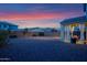 Spacious backyard with a covered patio perfect for relaxing and entertaining outdoors at dusk at 32347 N Vernal Ln, San Tan Valley, AZ 85144