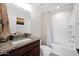 Bright bathroom features a granite countertop vanity and a shower and tub combination at 32347 N Vernal Ln, San Tan Valley, AZ 85144