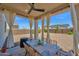Outdoor covered patio features furniture, ceiling fan, and views of the backyard and surrounding neighborhood at 32347 N Vernal Ln, San Tan Valley, AZ 85144