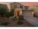 Exterior view of a well-maintained home featuring an arched entryway and meticulously landscaped front yard at 32347 N Vernal Ln, San Tan Valley, AZ 85144