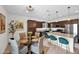 Stylish kitchen with dark wood cabinets, stainless steel appliances, granite countertops, island with bar seating, and a breakfast nook at 32347 N Vernal Ln, San Tan Valley, AZ 85144