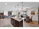 Open-concept kitchen featuring a large island, granite countertops, and stainless steel appliances adjacent to the dining area at 32347 N Vernal Ln, San Tan Valley, AZ 85144