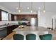 Contemporary kitchen featuring dark wood cabinets, stainless steel appliances, granite counters, and an island with pendant lighting at 32347 N Vernal Ln, San Tan Valley, AZ 85144