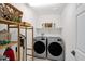 Well-organized laundry room equipped with modern washer and dryer units plus added storage at 32347 N Vernal Ln, San Tan Valley, AZ 85144