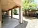 Covered patio and backyard featuring xeriscape landscaping, shade trees, and outdoor seating at 33506 N 24Th Dr, Phoenix, AZ 85085