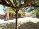 Spacious backyard featuring an outdoor kitchen, covered patio, mature shade trees, and xeriscaping at 33506 N 24Th Dr, Phoenix, AZ 85085