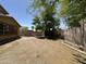 Large backyard featuring block walls, mature shade trees, and a simple xeriscaped yard at 33506 N 24Th Dr, Phoenix, AZ 85085