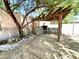 Backyard outdoor kitchen and bar area with stone accents and a wood pergola for shade at 33506 N 24Th Dr, Phoenix, AZ 85085