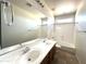 Bathroom featuring double sinks and a shower-tub combination at 33506 N 24Th Dr, Phoenix, AZ 85085