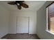 Cozy bedroom features a ceiling fan, neutral paint, and sliding door closet, creating a relaxing space at 33506 N 24Th Dr, Phoenix, AZ 85085