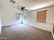 Carpeted bedroom with two windows providing natural light, complemented by a ceiling fan at 33506 N 24Th Dr, Phoenix, AZ 85085