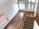Bright two-story foyer featuring wood-look floors and stairwell access to the upper level at 33506 N 24Th Dr, Phoenix, AZ 85085