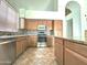 Spacious kitchen featuring an island, stainless steel appliances, tile flooring, and tile backsplash at 33506 N 24Th Dr, Phoenix, AZ 85085
