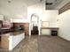 Open kitchen featuring a granite island, stainless steel appliances, and a cozy fireplace in the living area at 33506 N 24Th Dr, Phoenix, AZ 85085