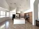 Bright, open kitchen featuring a granite island, stainless steel appliances, and tile flooring at 33506 N 24Th Dr, Phoenix, AZ 85085