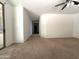 Spacious living room featuring neutral carpeting and ceiling fan for added comfort at 33506 N 24Th Dr, Phoenix, AZ 85085