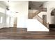 Open living area with wood-look flooring and a staircase to the second floor at 33506 N 24Th Dr, Phoenix, AZ 85085
