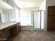 Well-lit main bathroom showcases a glass shower, soaking tub, and double sink vanity at 33506 N 24Th Dr, Phoenix, AZ 85085