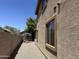 View of the side yard with gravel landscaping and a storage shed along the block wall at 33506 N 24Th Dr, Phoenix, AZ 85085
