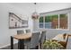 Bright dining area featuring modern light fixture and view of outdoors at 3402 E Sells Dr, Phoenix, AZ 85018