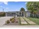 Contemporary home featuring desert landscaping, a unique paver walkway and a glass garage door at 3402 E Sells Dr, Phoenix, AZ 85018