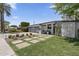 A modern home boasts desert landscaping, concrete pavers, and a stylish glass garage door at 3402 E Sells Dr, Phoenix, AZ 85018