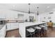 Modern kitchen featuring a large island with counter seating, sleek cabinetry, and stainless steel appliances at 3402 E Sells Dr, Phoenix, AZ 85018